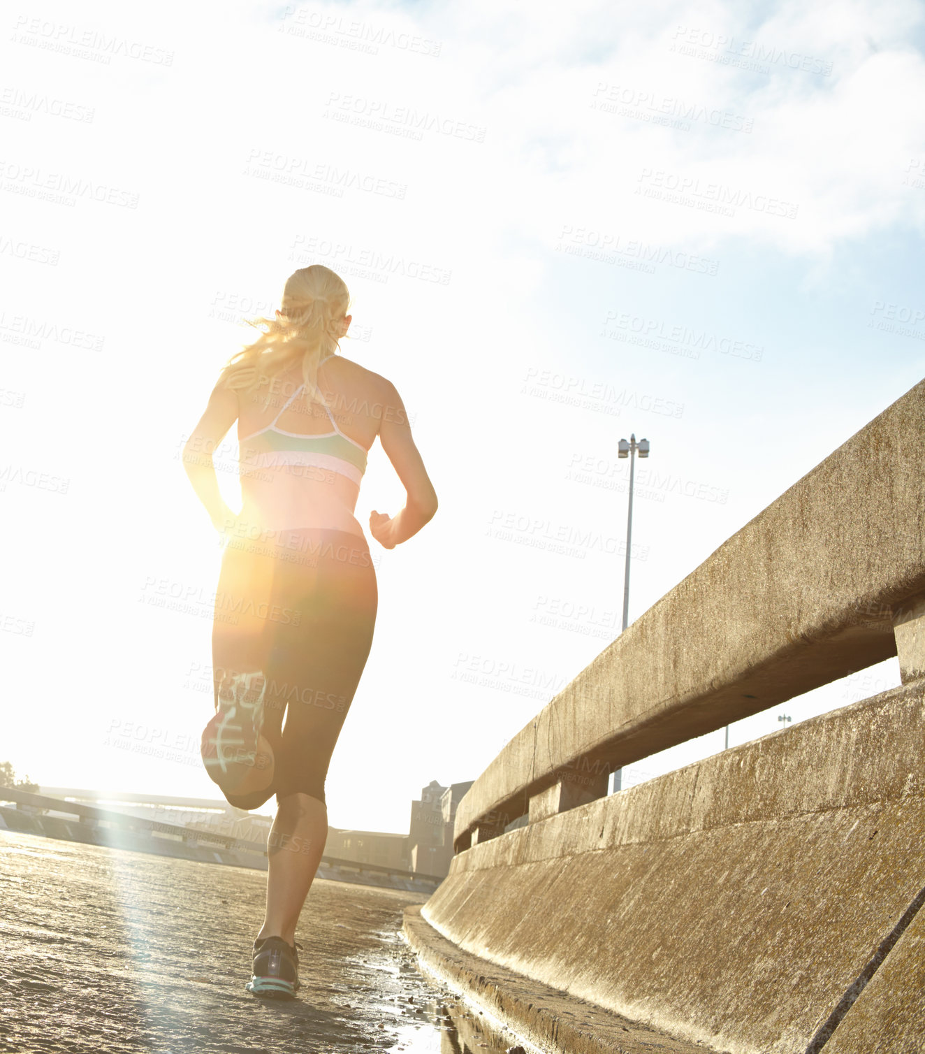 Buy stock photo Fitness, woman and back with running in street for cardio, workout and training for marathon. Low angle, morning and athlete with energy on road for outdoor sports, exercise and endurance in Germany