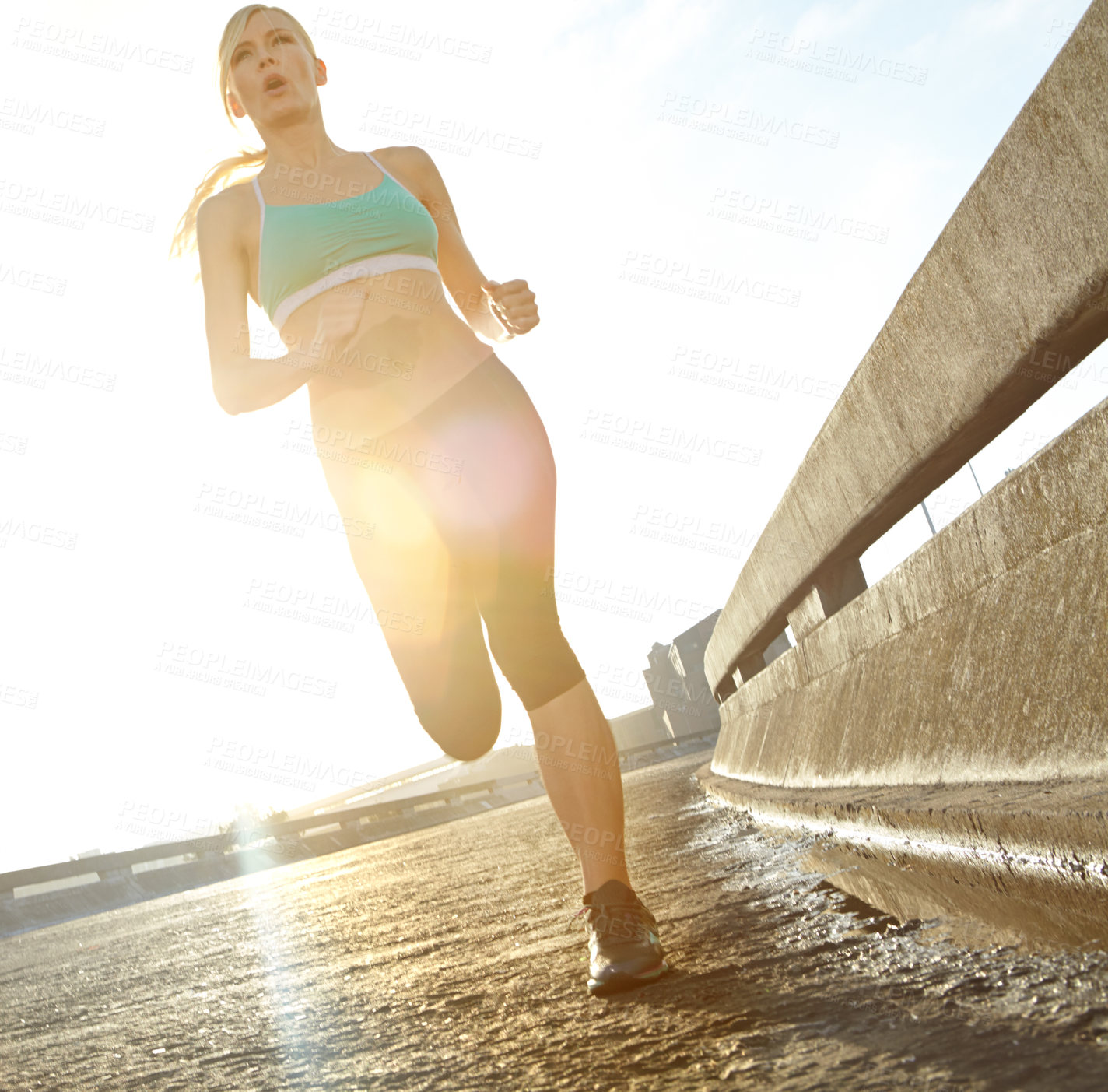 Buy stock photo Fitness, woman and challenge with running in street for sports, exercise and training for marathon. Low angle, morning and athlete with sunshine on road for outdoor cardio, workout and endurance