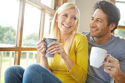 Buy stock photo Happy couple, laughing and window with coffee for bonding, morning or holiday weekend together at home. Young man, woman and smile, laughter or drink in friendly discussion or conversation at house