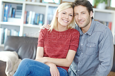 Buy stock photo Portrait of a young couple sitting together in their living room