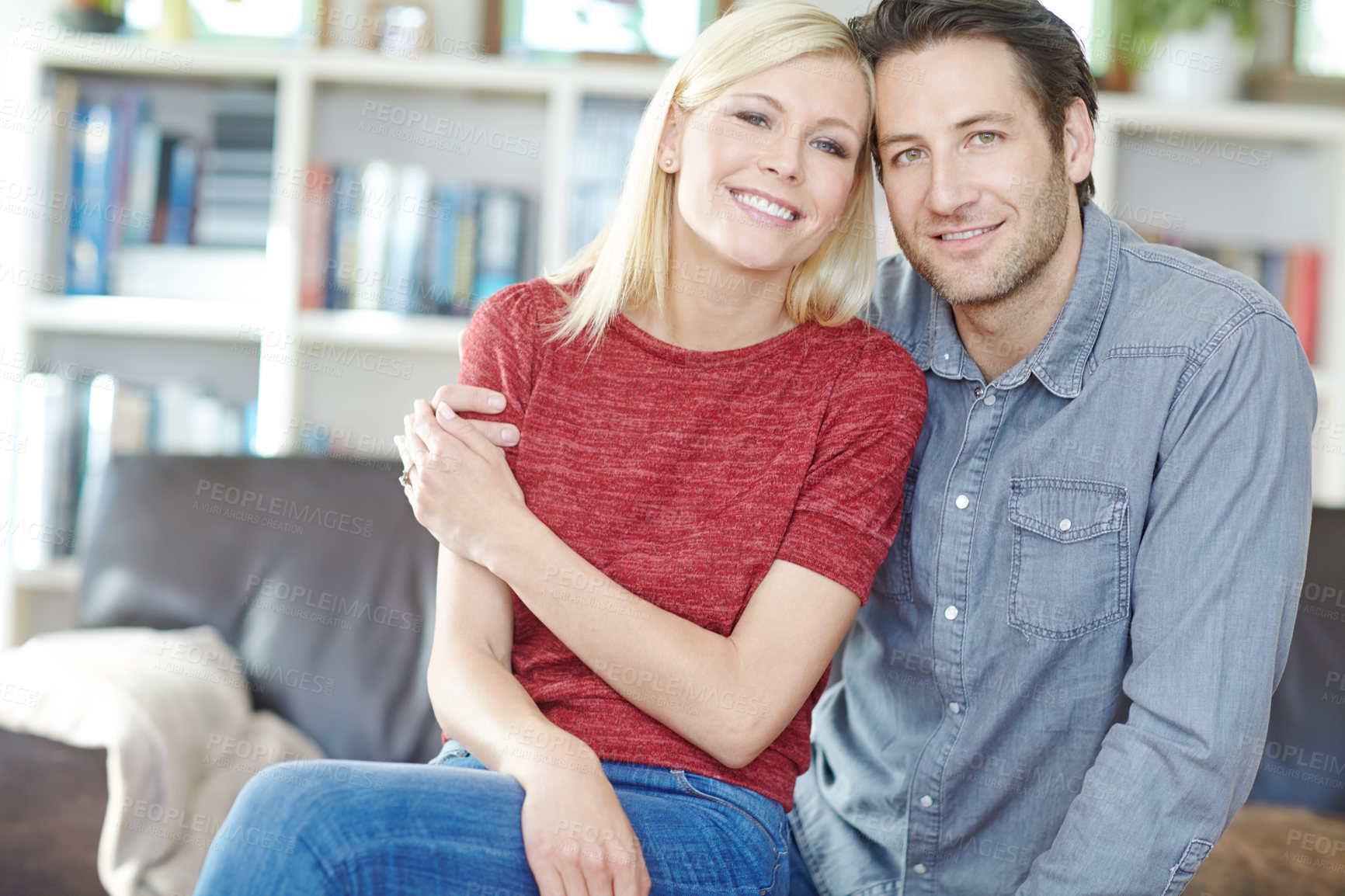 Buy stock photo Couple, portrait and hug on sofa in home living room, bonding or relaxing and having fun. Smile, man and woman sitting on couch for embrace or love, happiness and security together for support