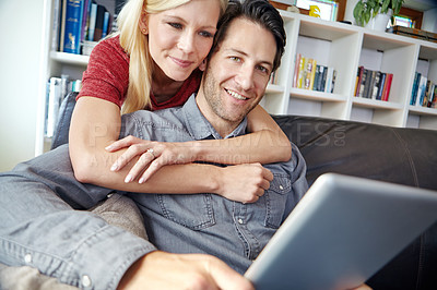 Buy stock photo Happy, couple and hug in living room with tablet, relax online and people smile for internet browse together. Social media, web and scrolling for relationship bonding, networking and home apartment