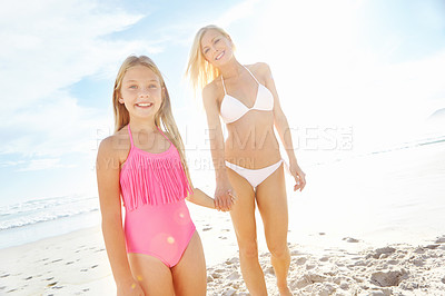 Buy stock photo Portrait of a happy mother and daughter enjoying a sunny day at the beach together