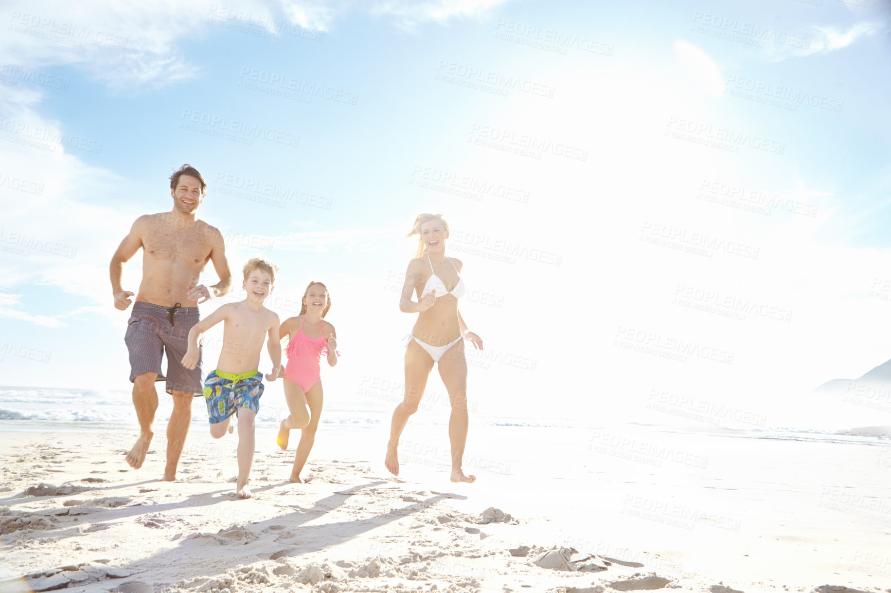 Buy stock photo Portrait, beach and family running with happiness, weekend break and bonding together with holiday. Parents, mother or father with children, kids and seaside for vacation, fun or travel with sunshine