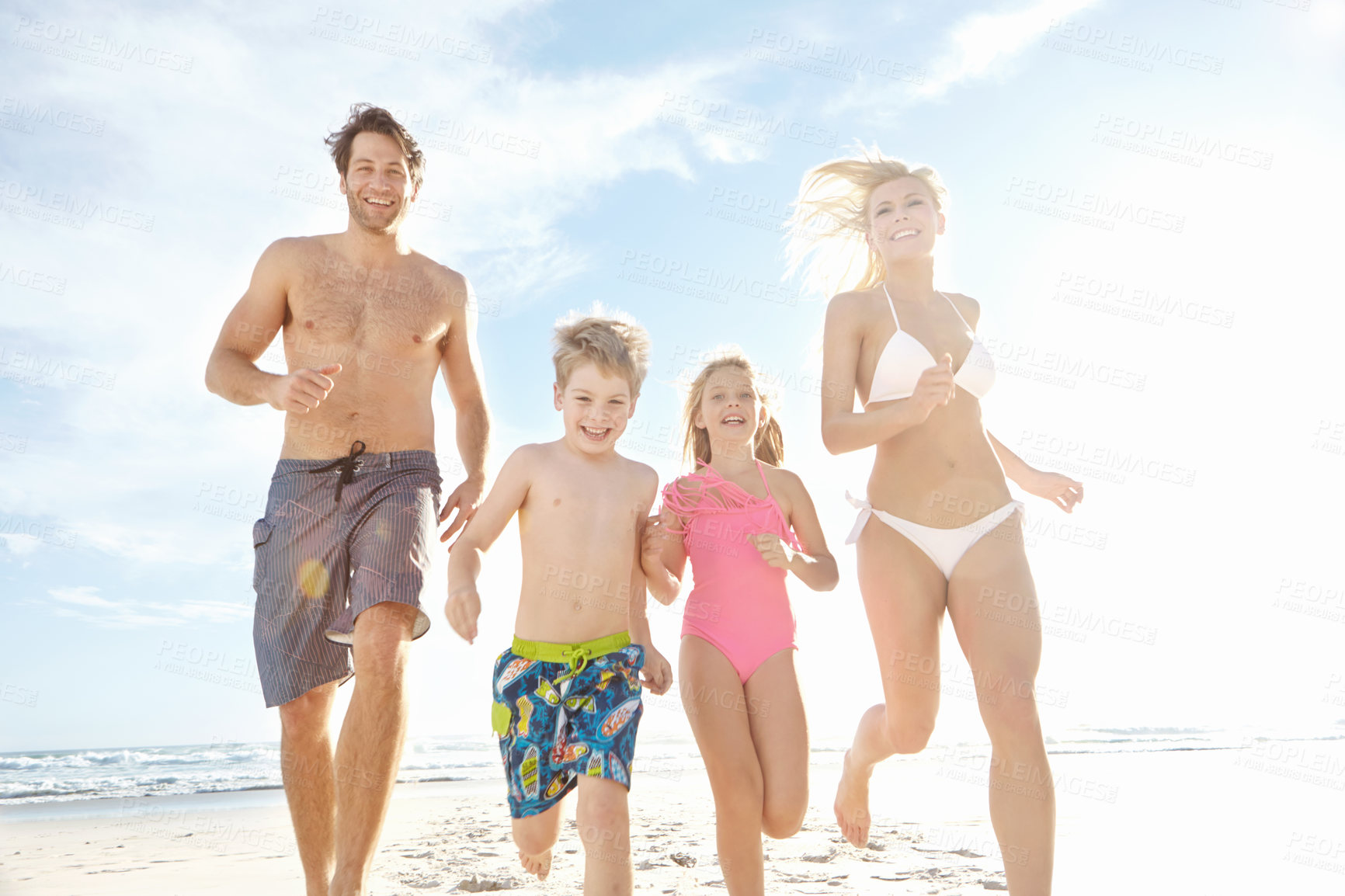 Buy stock photo Portrait, beach and running with kids, family and happiness with weekend break, travel and bonding together. Parents, mother or father with children, sunshine and seaside for holiday and getaway trip