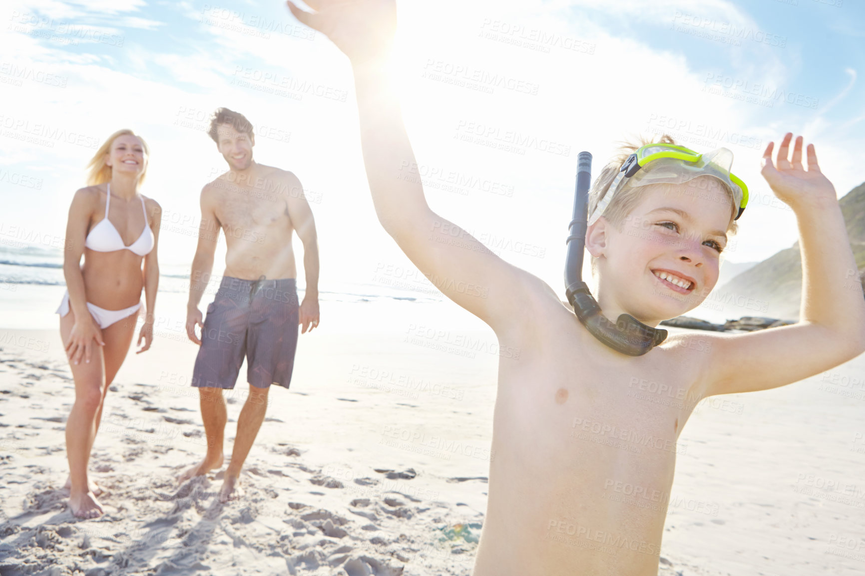 Buy stock photo Boy, running and happy at beach for vacation, adventure and travel for holiday in summer. Mother, father and family in nature with smile, energy and sunshine in Bali with parents and freedom by ocean