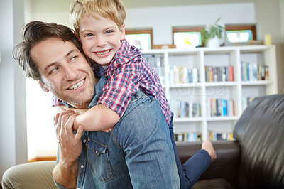 Buy stock photo Portrait, dad and child on sofa with embrace, bonding and love in living room for playful family in home. Relax, father and son on couch for happy weekend together with fun, smile and piggy back.