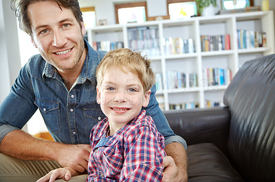 Buy stock photo Shot of a young father and son spending time together at home