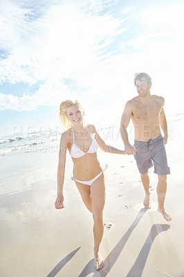 Buy stock photo Holding hands, running and portrait of couple on beach for travel, vacation or holiday with romance together. Happy, summer and young people walking by ocean for bonding on weekend trip in Australia.