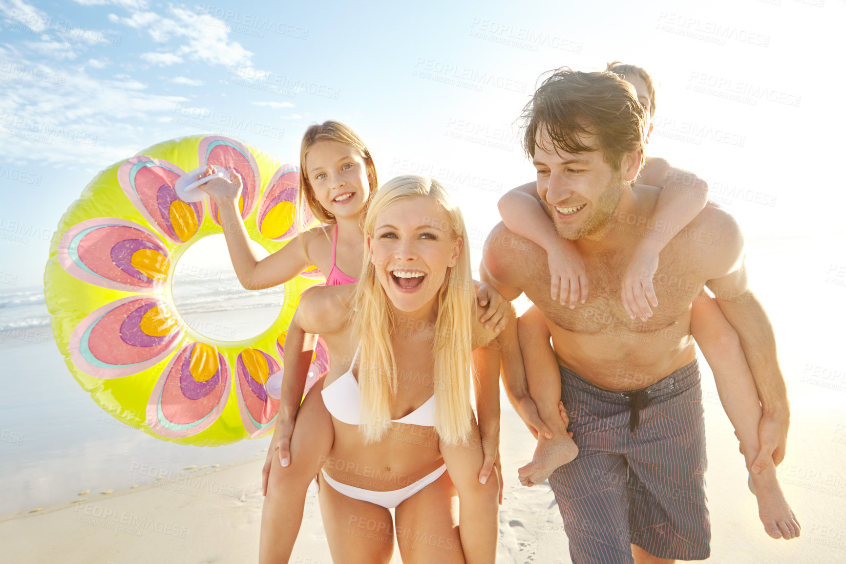 Buy stock photo Happy, family and children on back at beach together for bonding, relax and love for adventure in summer sunshine. Parents, kids and playful on vacation, care and support with ocean in Brazil