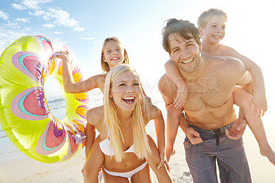 Buy stock photo Portrait, parents and children with piggyback on beach for vacation, holiday and trip in California. Outdoor, ocean and seaside with happy family, man and woman with daughter and son for bonding