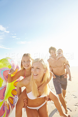 Buy stock photo Shot of a happy young family having fun at the beach