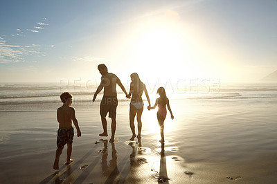 Buy stock photo Family, beach and holding hands by ocean for holiday, vacation and summer together in silhouette. Parents with children by sea and sunshine for support, game and playing with love or travel adventure