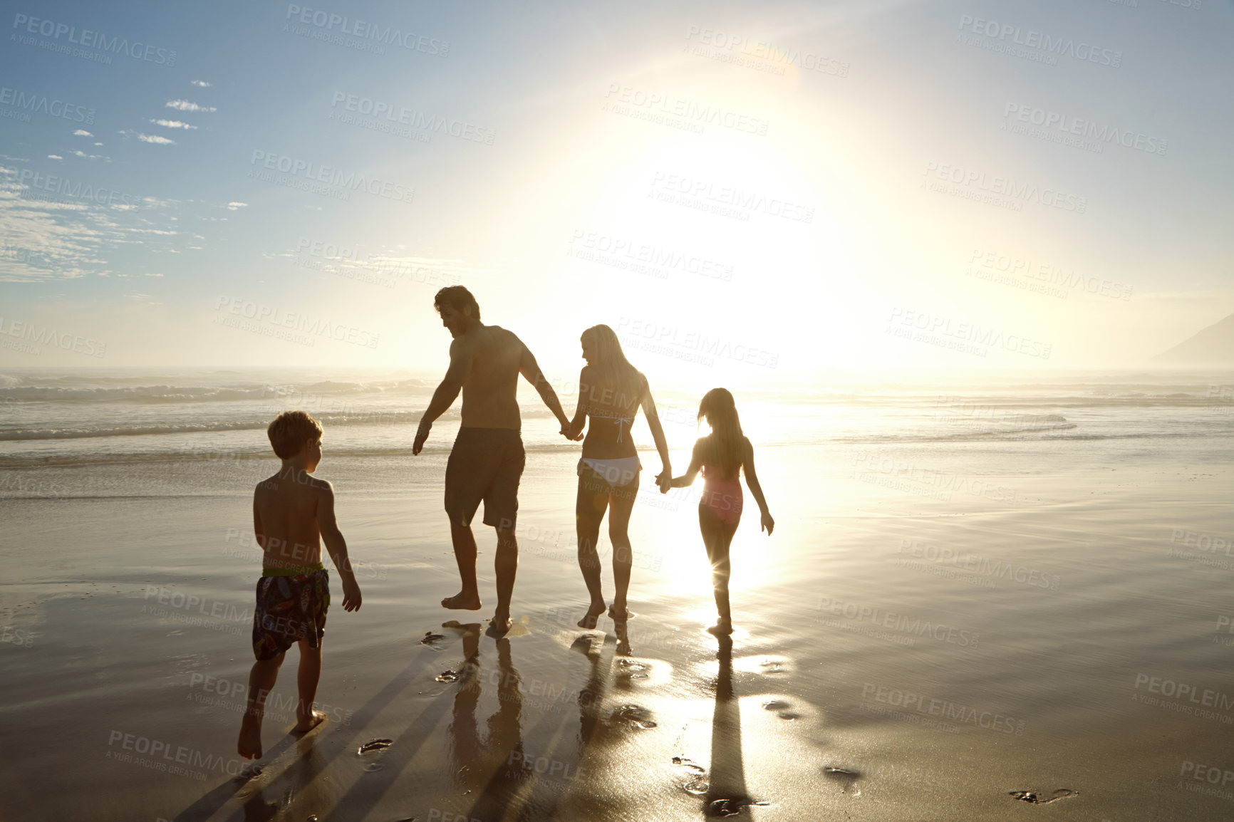 Buy stock photo Family, beach and holding hands by ocean for holiday, vacation and summer together in silhouette. Parents with children by sea and sunshine for support, game and playing with love or travel adventure