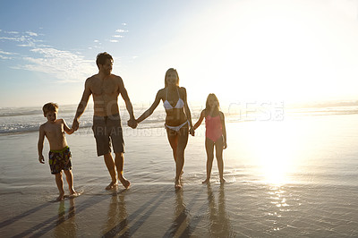 Buy stock photo Sunset, love and family holding hands at a beach for summer, fun and bonding in nature together. Travel, people and children with parents at sea for vacation, journey or tropical adventure in Florida