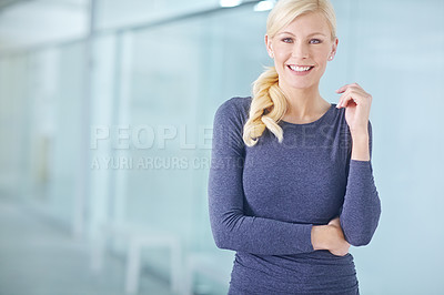 Buy stock photo Portrait of a businesswoman standing with her arms crossed, smiling and looking at the camera while her colleagues stand in the background. One female entrepreneur leader ready for business success
