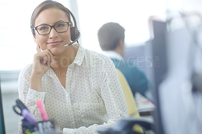Buy stock photo Shot of an attractive young customer service representative working at her desk in an office