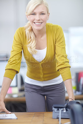 Buy stock photo Shot of an attractive young woman standing in an office
