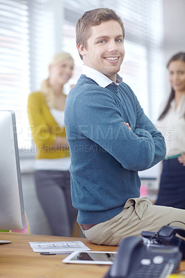 Buy stock photo Portrait of a handsome young businessman with his colleagues in the background