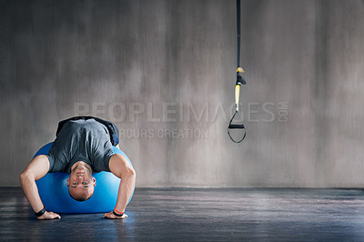 Buy stock photo Man, physio ball and stretch for back strength, health or wellness in fitness studio. Sports trainer, working out and demonstrating exercise for motivation, lumbar mobility and flexibility in gym