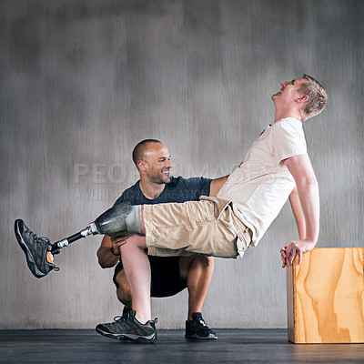 Buy stock photo Trainer, person with a disability and prosthetic leg and training in physiotherapy, studio and gym block. Male people, physiotherapist and amputee for wellness, fitness and exercise in rehab center
