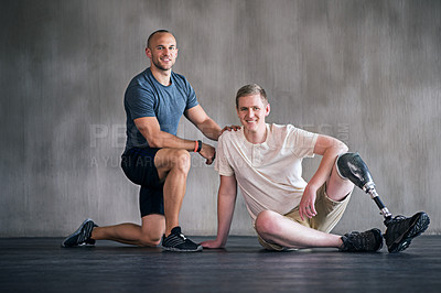 Buy stock photo Trainer, person with a disability and prosthetic leg and posing in physiotherapy, studio and workout. Male people, physiotherapist and amputee for wellness, fitness and exercise in sports center
