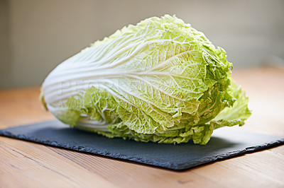 Buy stock photo Whole vegetable, fresh and cutting board in kitchen for diet, cooking and wellness. Cabbage, green and natural produce for food, nutrition and vegan in house for salad leaves, food and gut health.