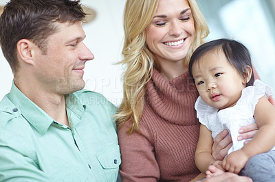 Buy stock photo Happy family, parents and foster baby in home for custody, support and bonding together. Mother, kid and father with cute adopted child for connection, diversity and interracial care with toddler