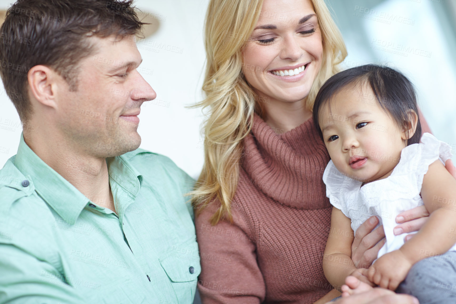 Buy stock photo Happy family, parents and foster baby in home for custody, support and bonding together. Mother, kid and father with cute adopted child for connection, diversity and interracial care with toddler