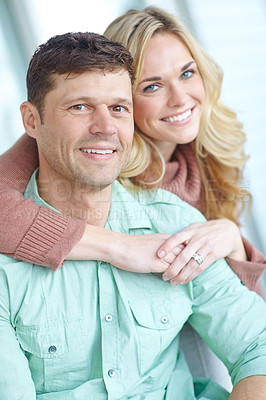 Buy stock photo Portrait, hug and happy couple in home for love or bonding together to relax in living room. Face, man and woman in house together to embrace for support, marriage or relationship commitment