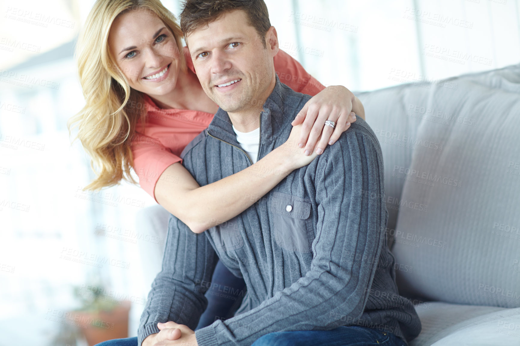 Buy stock photo Portrait of an affectionate and happy mature couple spending time together while relaxing at home