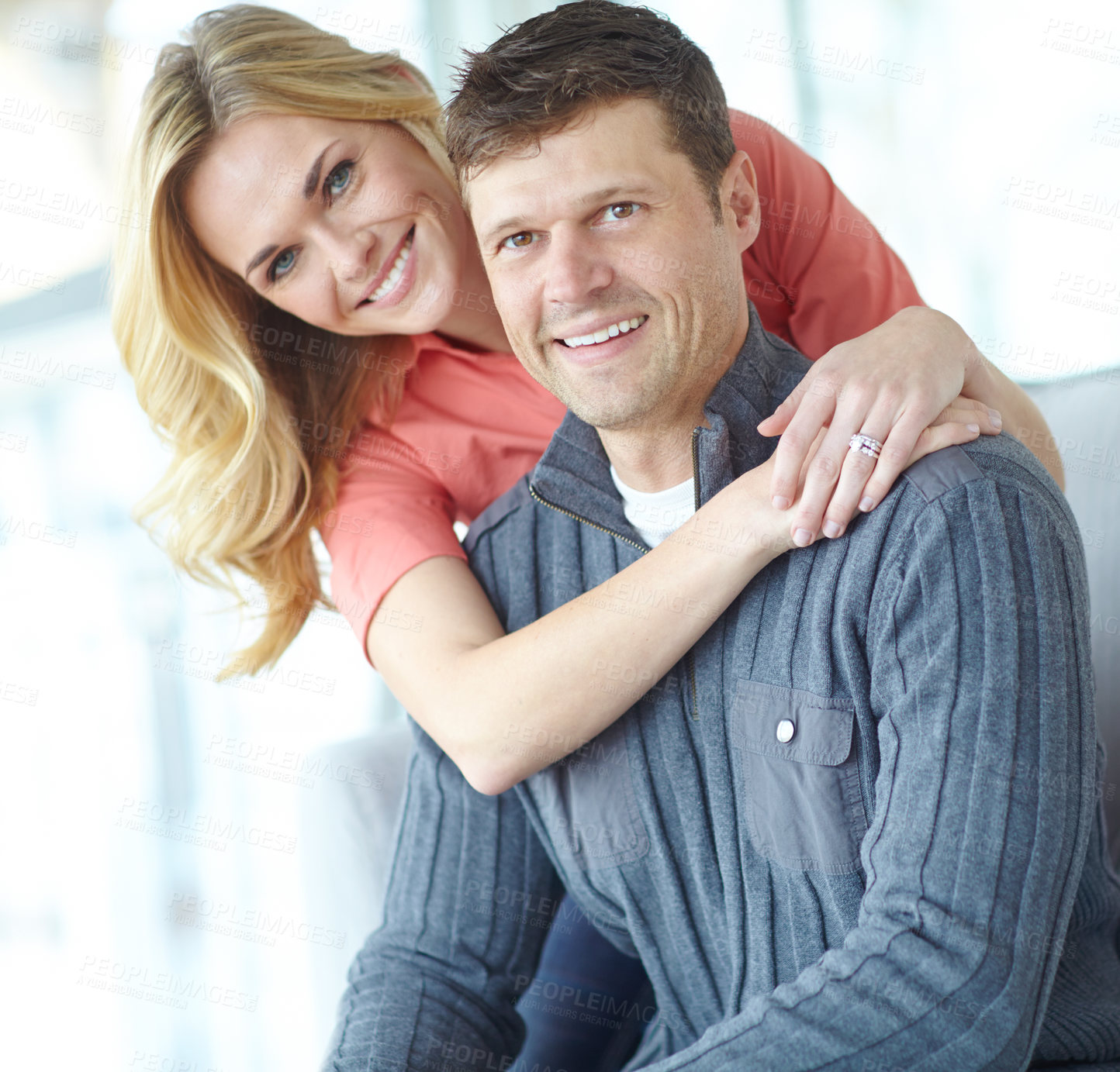 Buy stock photo Portrait of an affectionate and happy mature couple spending time together while relaxing at home