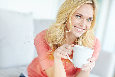 Buy stock photo Portrait of a beautiful young woman drinking coffee while relaxing at home
