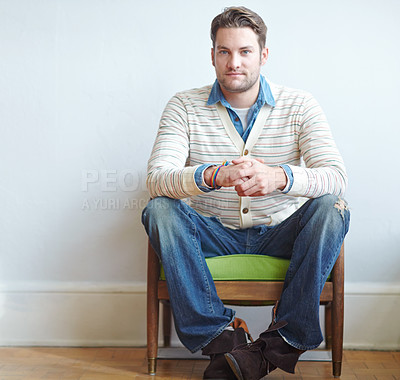 Buy stock photo Man, chair and wall background with portrait waiting, therapist office and mental health check up. Patient, sitting and psychology for therapy session, anxious anticipation and fiddle with hands