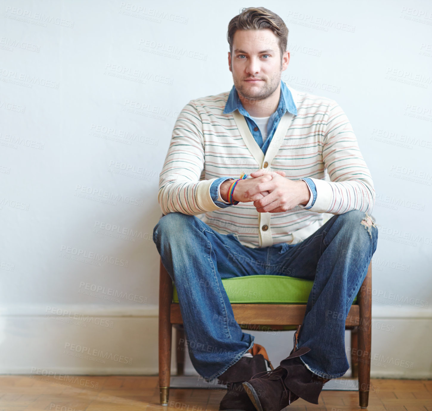 Buy stock photo Man, chair and wall background with portrait waiting, therapist office and mental health check up. Patient, sitting and psychology for therapy session, anxious anticipation and fiddle with hands