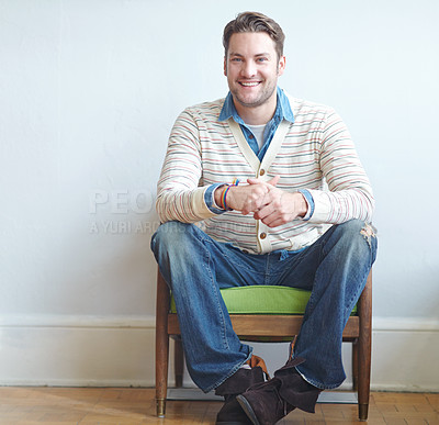 Buy stock photo Man, chair and white background or portrait waiting, therapist office and mental health check up. Patient, sitting and psychology for session, smile and masking emotion with nervous hand gesture