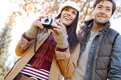 Buy stock photo People, couple and happy in forest with photography or digital camera as nature lovers and bonding in Germany. Relationship, love and smile in woods on winter holiday, sightseeing and adventure