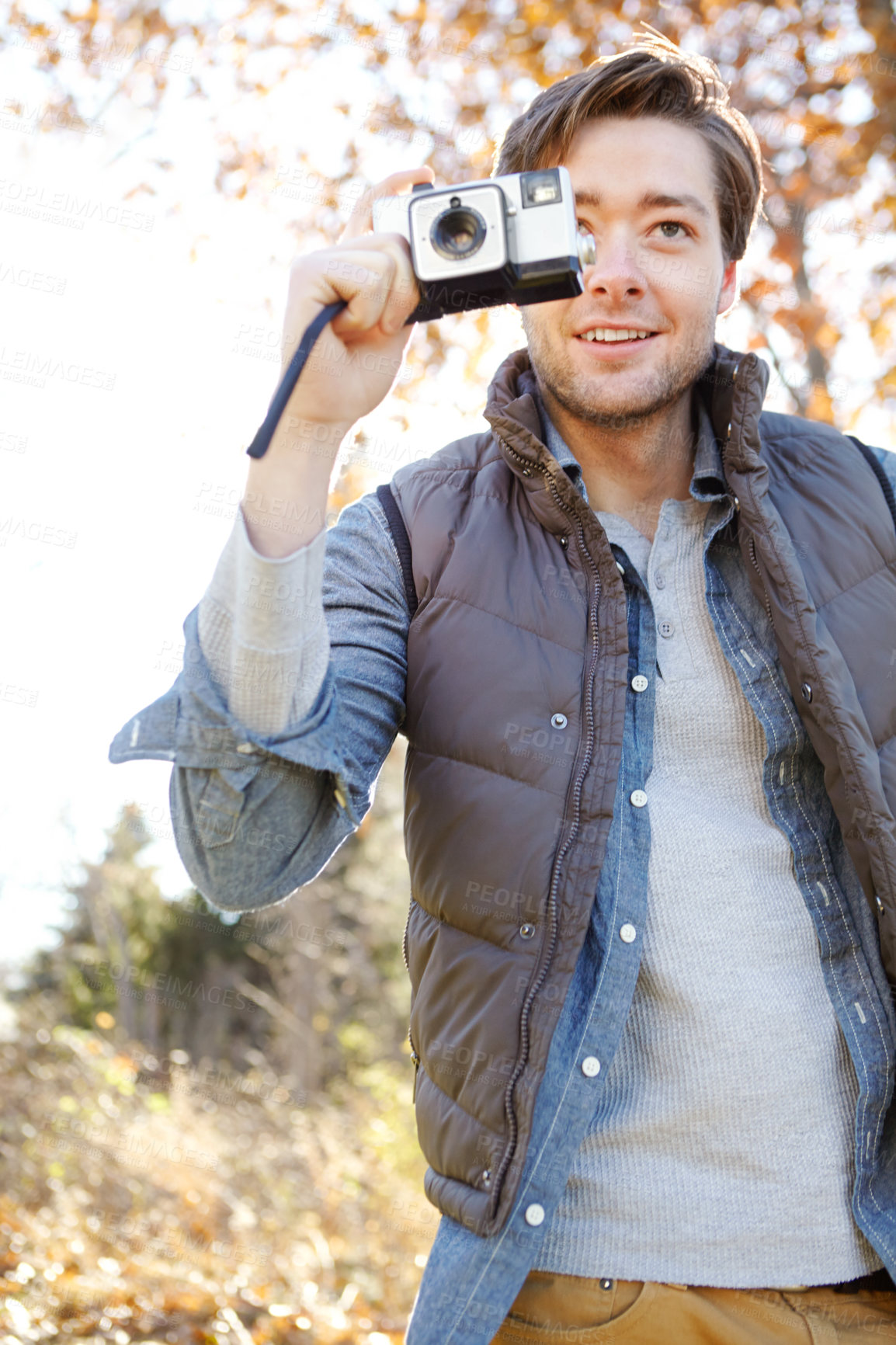 Buy stock photo Man, photography and smile with camera outdoor with adventure travel, explore nature and sightseeing memory. Happy, male photographer and relax with vintage equipment for scenery of destination