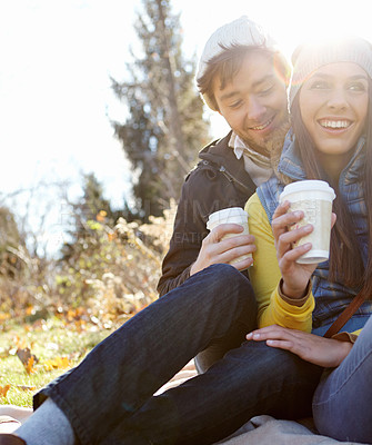 Buy stock photo Couple, smile and relax with coffee in nature for bonding, picnic and winter adventure with lens flare. People, happy and caffeine drink in forest on holiday, vacation or together in woods for travel