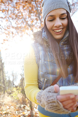 Buy stock photo Trees, hiking and woman with phone for outdoor adventure, location search or connection on holiday in nature. Smile, trekking and girl in forest with smartphone for online map, direction or check in