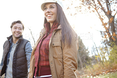 Buy stock photo Woman, man and walk with nature for park trip, bonding or travel in winter countryside. Smile, love and happy couple in holding hands for morning holiday, vacation or woods picnic or hiking adventure