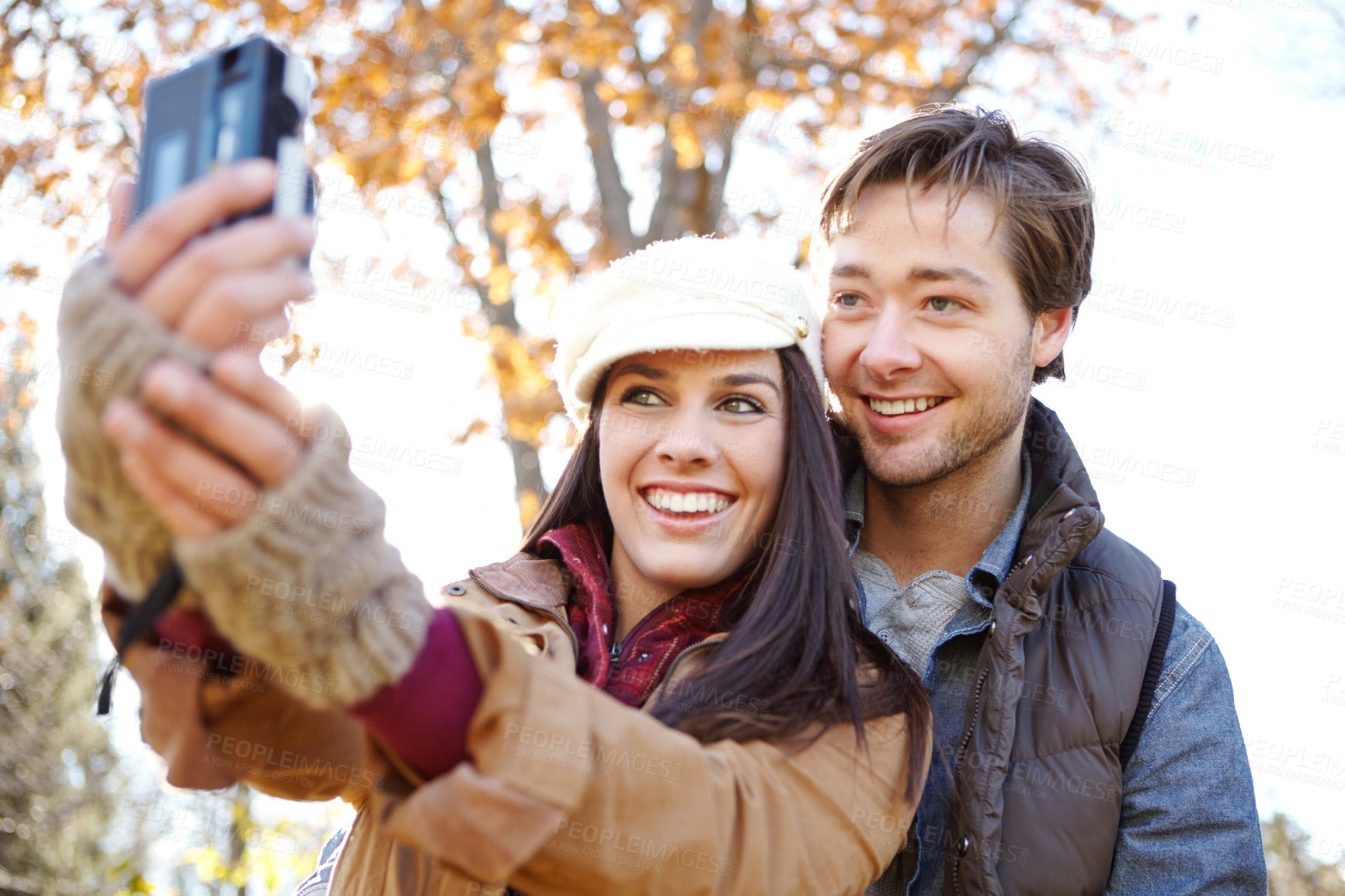 Buy stock photo People, couple and smile in park with selfie for social media or profile picture as nature lovers in Germany. Relationship, love and happy in forest on winter holiday, sightseeing and adventure