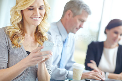 Buy stock photo Phone, smile and business woman reading email, app or typing project feedback in meeting. Mobile, scroll or journalist on internet for news article review, info or creative research with startup team