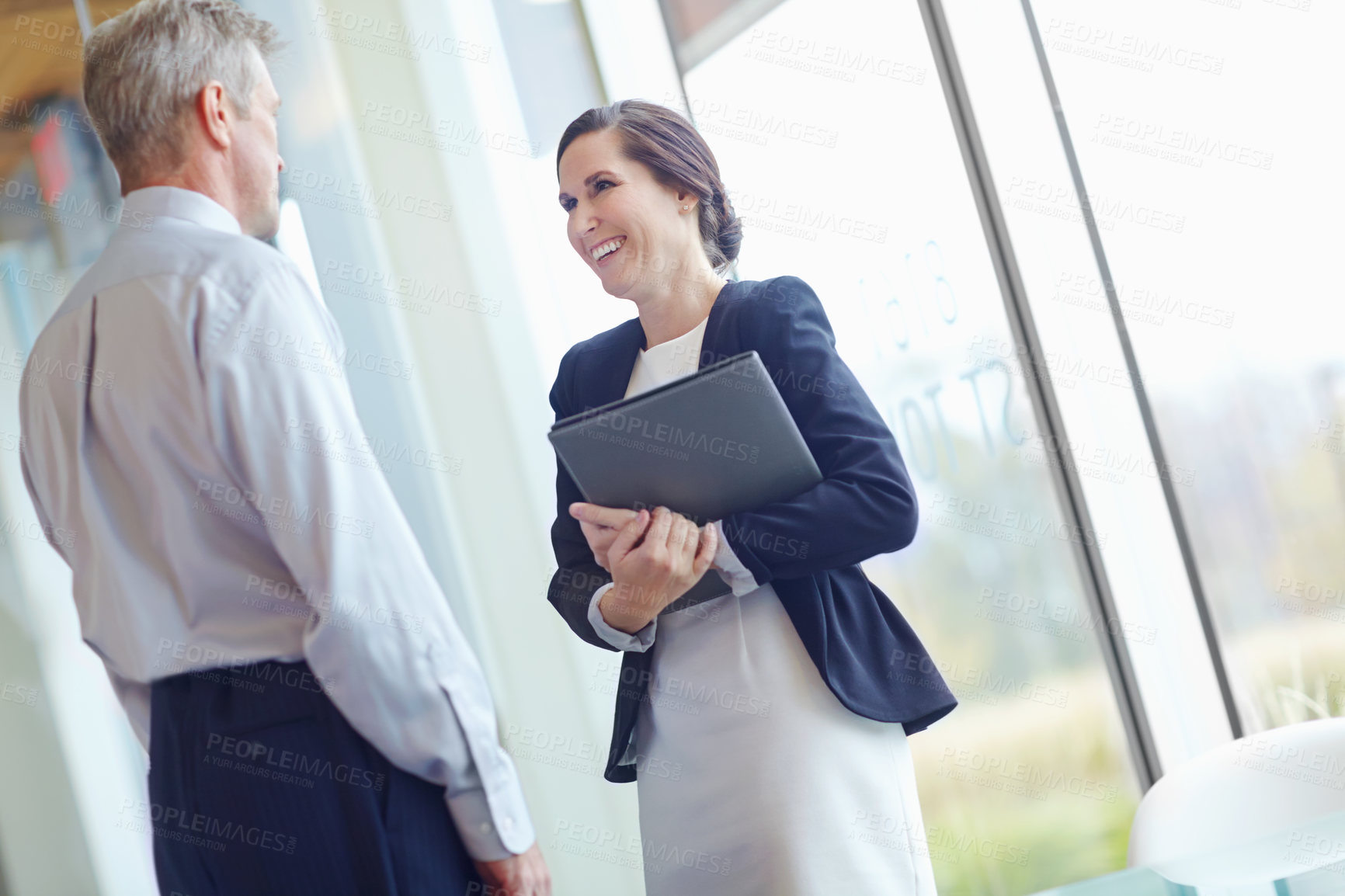 Buy stock photo Conversation, folder and laughing with business people in office together for feedback or review. Collaboration, documents or funny with happy employee and mentor planning in corporate workplace