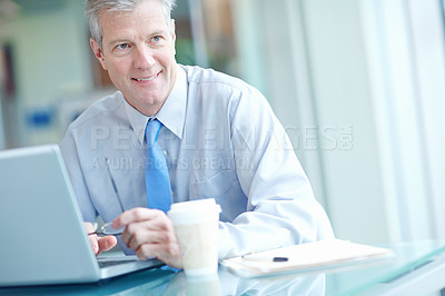 Buy stock photo Laptop, smile and thinking with mature businessman at desk in office for future, planning or vision. Coffee, computer and report with happy employee in corporate workplace for online administration