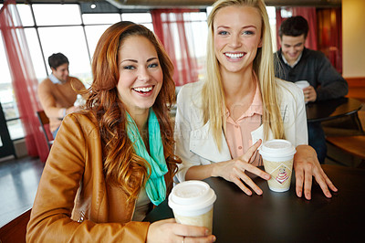 Buy stock photo Two attractive young female friends enjoying a cup of coffee together