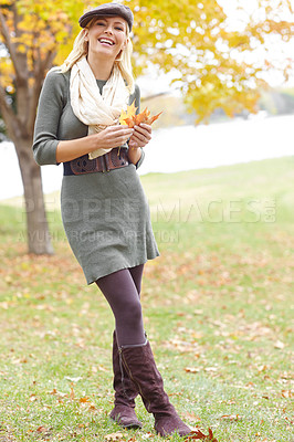 Buy stock photo Fashion, portrait and woman with leaf in nature for Autumn weather on holiday, getaway or vacation. Smile, outdoor and female person from Denmark with stylish outfit in park or field on weekend trip.