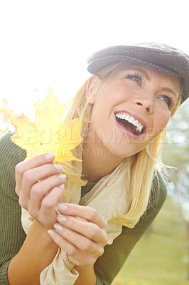 Buy stock photo Woman, joyful and leaf in nature during autumn season for leisure, happy and fun outdoor on holiday. Female person, excited and smile in park in fall weather for travel, vacation and positive mood