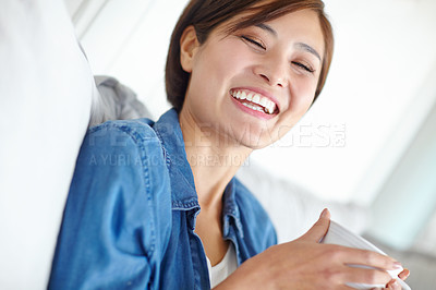 Buy stock photo An attractive Asian woman enjoying a cup of coffee
