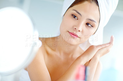 Buy stock photo Asian woman, bathroom and beauty by mirror, portrait or moisturizer for results with reflection in home. Person, towel and grooming routine for skincare, wellness and product for cosmetics in morning